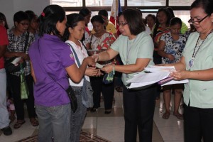 DSWD-NCR Director Ma. Alicia S. Bonoan while awarding livelihood assistance to Pantawid Pamilya beneficiaries during the DSWD-NCR flag ceremony.