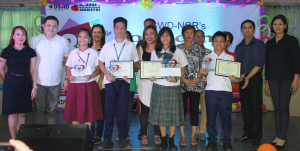 In photo are Ms. Hazel T. Militante, Chief of Protective Services Unit (from extreme left), Mr. Joel D. Cam, Pantawid Pamilya Regional Program Coordinator, Dennine Angela Cabarles the 2nd runner-up from Pateros, John Marc Bañares the 1st runner-up from Caloocan City, Angelica Macainag, the winner from Valenzuela City, John Marc Bañares, the 3rd runner-up from Makati City, DSWD-NCR Regional Director Mr. Vincent Andrew T. Leyson and Assistant Regional Director for Operations Ms. Jacel J. Paguio. The people behind them are the relatives of the mentioned children.